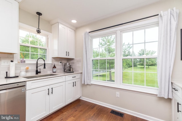 534 Country Club Dr, Lansdale, PA 19446 - kitchen with stainless steel dishwasher, a sink, dark wood-style floors, backsplash, and baseboards