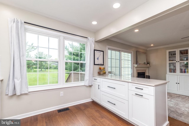 534 Country Club Dr, Lansdale, PA 19446 - kitchen with a peninsula, white cabinetry, dark wood-style flooring, a fireplace, and baseboards