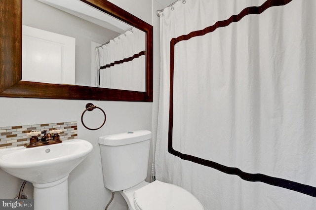11214 Midvale Rd, Kensington, MD 20895 - bathroom featuring tasteful backsplash, toilet, curtained shower, and a sink