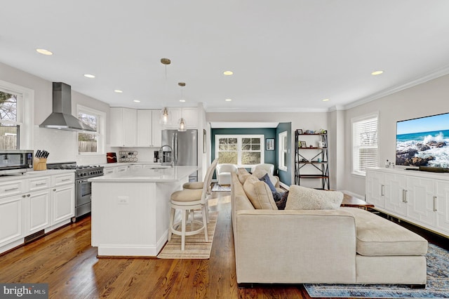 11214 Midvale Rd, Kensington, MD 20895 - kitchen with wall chimney exhaust hood, appliances with stainless steel finishes, open floor plan, plenty of natural light, and crown molding