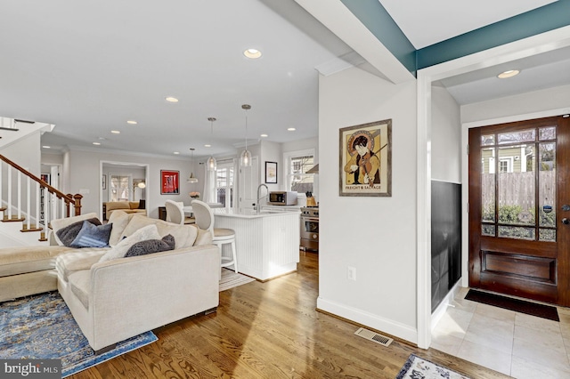 11214 Midvale Rd, Kensington, MD 20895 - foyer featuring stairway, recessed lighting, light wood-style floors, baseboards, and ornamental molding