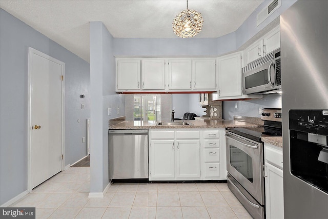 12626 Sunset Ave Unit 62, Ocean City, MD 21842 - kitchen with appliances with stainless steel finishes, a sink, white cabinetry, light tile patterned flooring, and a textured ceiling