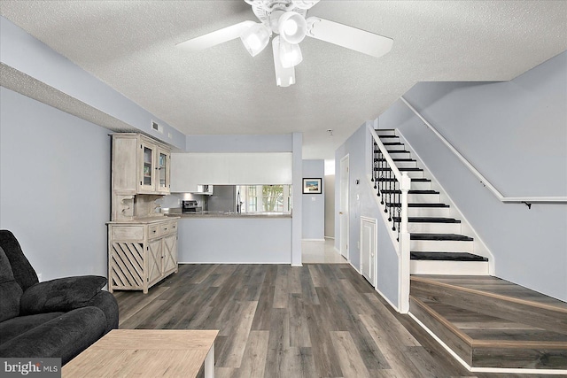 12626 Sunset Ave Unit 62, Ocean City, MD 21842 - living room with stairway, a textured ceiling, ceiling fan, and dark wood finished floors