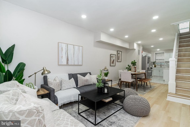 143 N Decker Ave, Baltimore, MD 21224 - living area featuring light wood-type flooring, stairs, recessed lighting, and baseboards