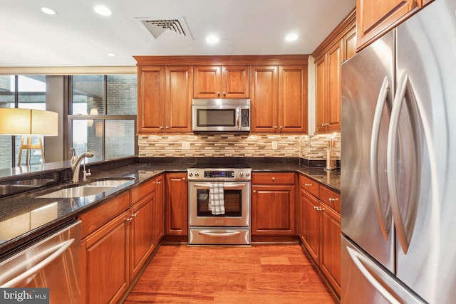 1500 Chestnut St Unit 20K, Philadelphia, PA 19102 - kitchen with appliances with stainless steel finishes, a sink, brown cabinets, and recessed lighting
