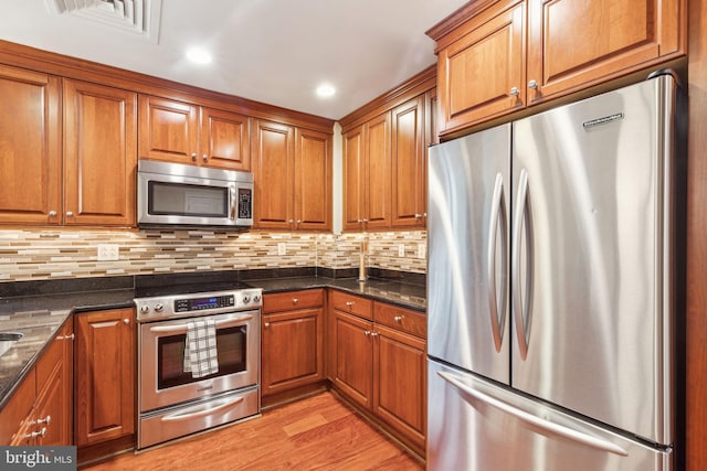 1500 Chestnut St Unit 20K, Philadelphia, PA 19102 - kitchen featuring stainless steel appliances, brown cabinets, and recessed lighting