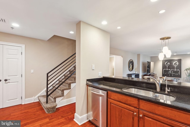 1500 Chestnut St Unit 20K, Philadelphia, PA 19102 - kitchen featuring dishwasher, a sink, dark stone counters, dark wood-style flooring, and pendant lighting