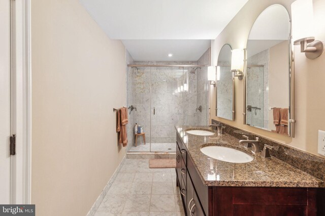 1500 Chestnut St Unit 20K, Philadelphia, PA 19102 - bathroom featuring double vanity, a stall shower, and baseboards