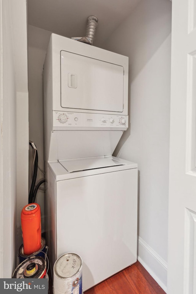1500 Chestnut St Unit 20K, Philadelphia, PA 19102 - laundry room featuring stacked washing machine and dryer and wood finished floors