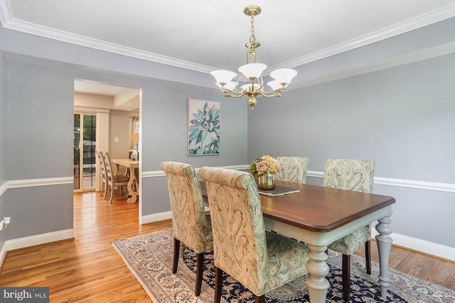 13704 Beret Pl, Silver Spring, MD 20906 - dining space featuring a chandelier, light wood-type flooring, ornamental molding, and baseboards