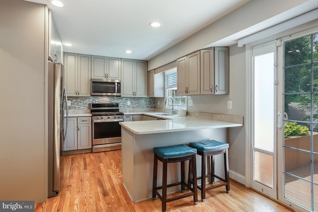 13704 Beret Pl, Silver Spring, MD 20906 - kitchen featuring stainless steel appliances, gray cabinetry, light wood-style flooring, a peninsula, and recessed lighting