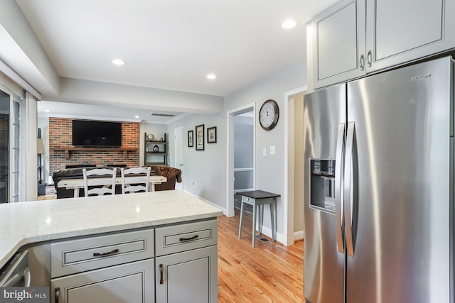 13704 Beret Pl, Silver Spring, MD 20906 - kitchen with stainless steel refrigerator with ice dispenser, gray cabinetry, light wood-style flooring, light stone countertops, and open floor plan