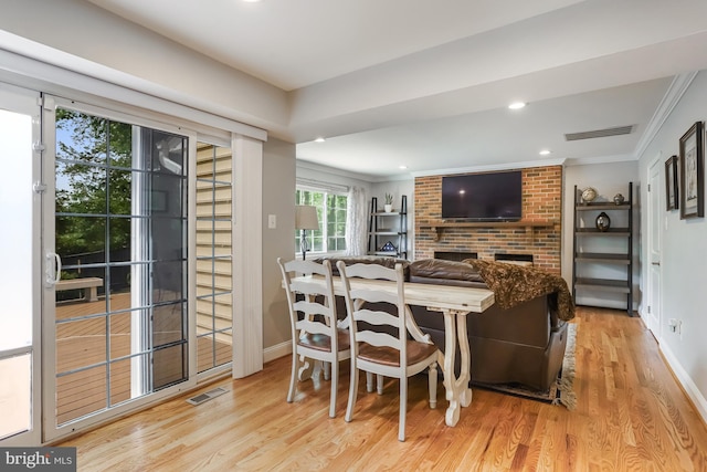 13704 Beret Pl, Silver Spring, MD 20906 - dining area featuring wood finished floors, recessed lighting, ornamental molding, a brick fireplace, and baseboards