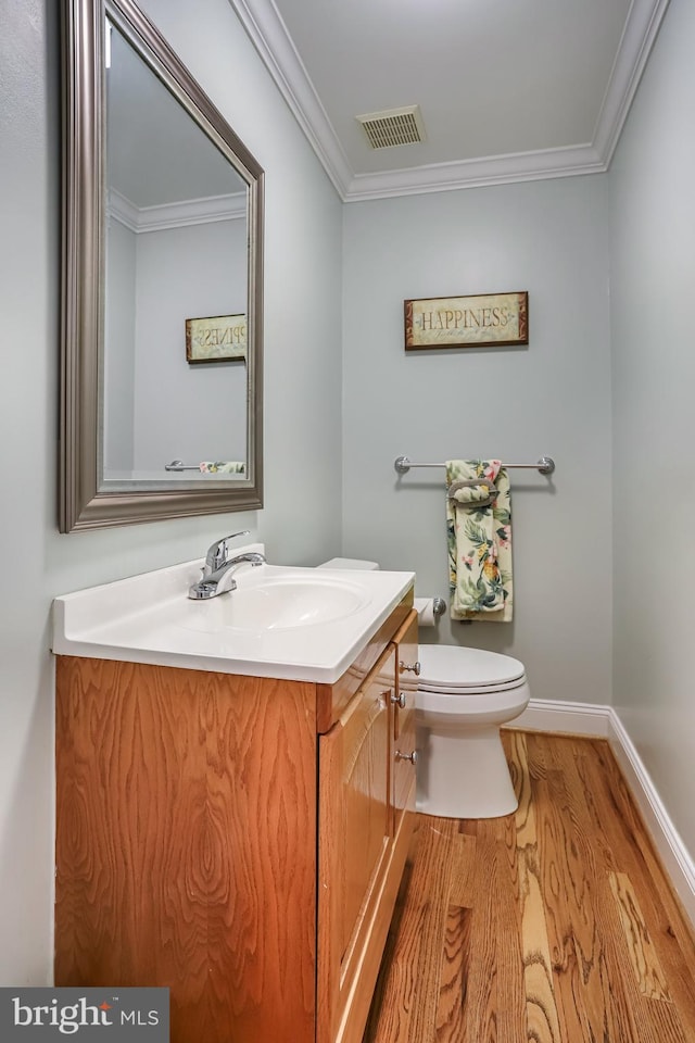 13704 Beret Pl, Silver Spring, MD 20906 - half bathroom featuring wood finished floors, toilet, vanity, crown molding, and baseboards