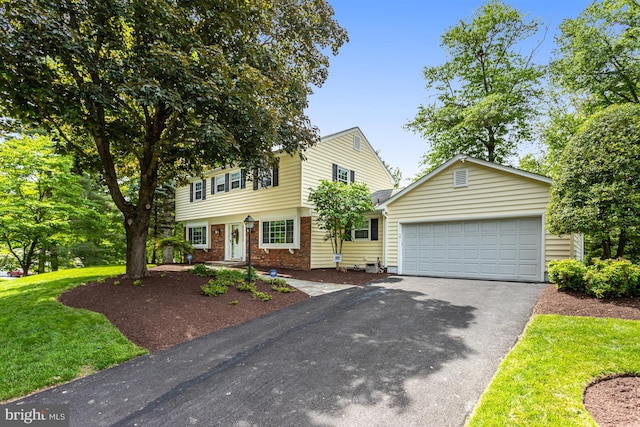 13704 Beret Pl, Silver Spring, MD 20906 - colonial inspired home with asphalt driveway, an attached garage, brick siding, and a front lawn