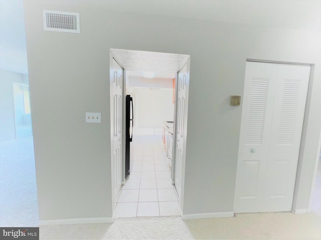 8015 Mandan Rd Unit 203, Greenbelt, MD 20770 - hall featuring light colored carpet, baseboards, and light tile patterned flooring