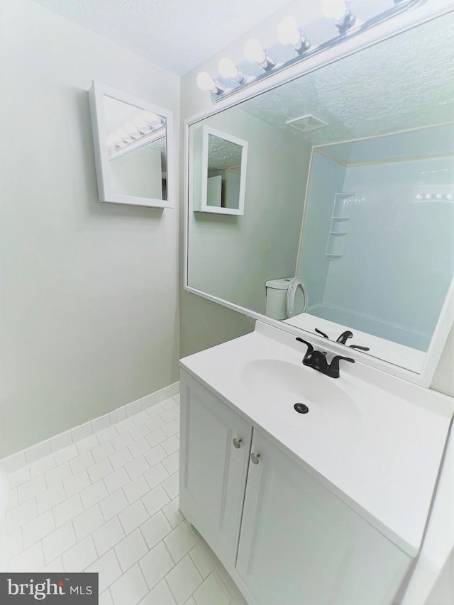 8015 Mandan Rd Unit 203, Greenbelt, MD 20770 - bathroom featuring tile patterned floors, vanity, a textured ceiling, and toilet