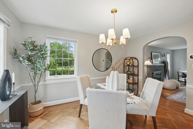711 Avon Pl, Alexandria, VA 22314 - dining room featuring arched walkways, a chandelier, and baseboards