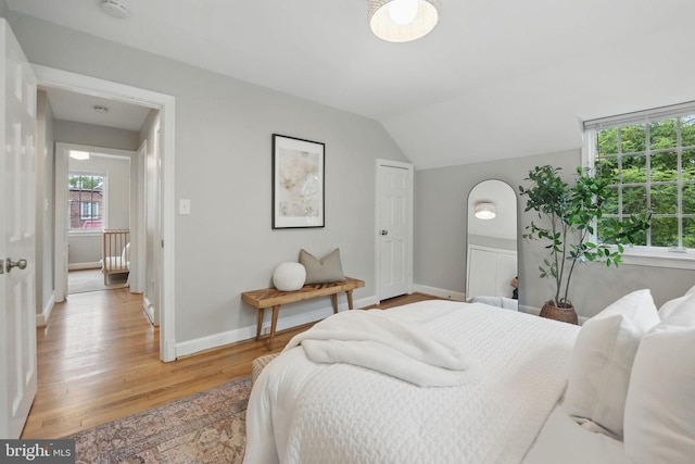 711 Avon Pl, Alexandria, VA 22314 - bedroom with light wood-style floors, baseboards, and lofted ceiling