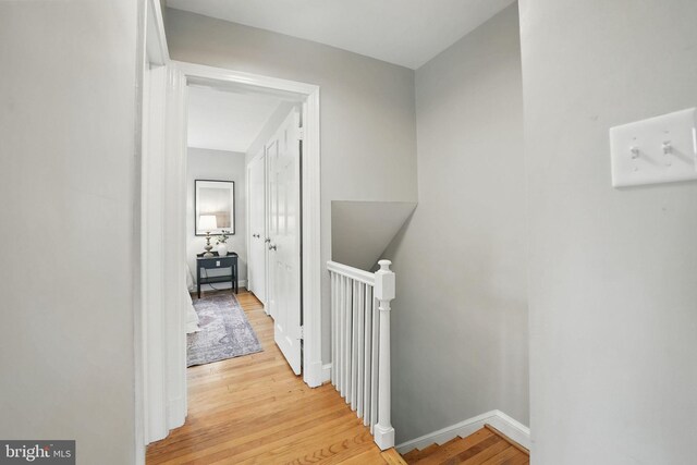 711 Avon Pl, Alexandria, VA 22314 - corridor with an upstairs landing, light wood-type flooring, and baseboards