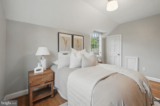 711 Avon Pl, Alexandria, VA 22314 - bedroom with vaulted ceiling, wood finished floors, and baseboards