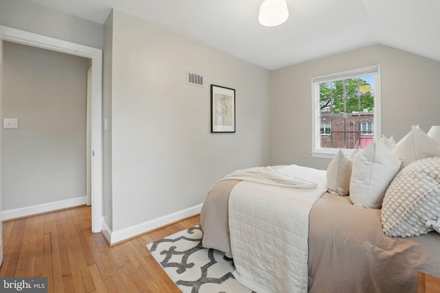 711 Avon Pl, Alexandria, VA 22314 - bedroom with baseboards, light wood finished floors, and vaulted ceiling