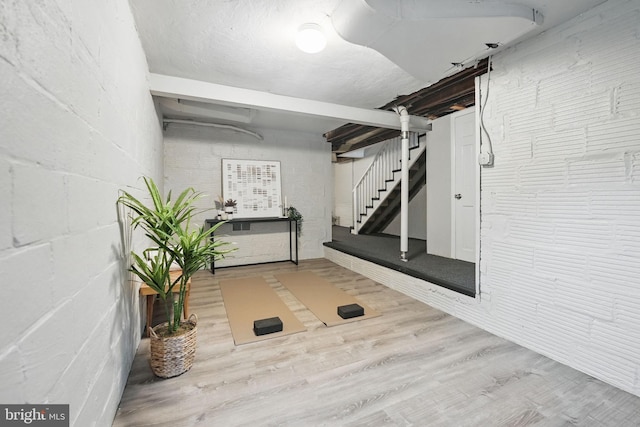 711 Avon Pl, Alexandria, VA 22314 - workout room featuring wood finished floors and concrete block wall