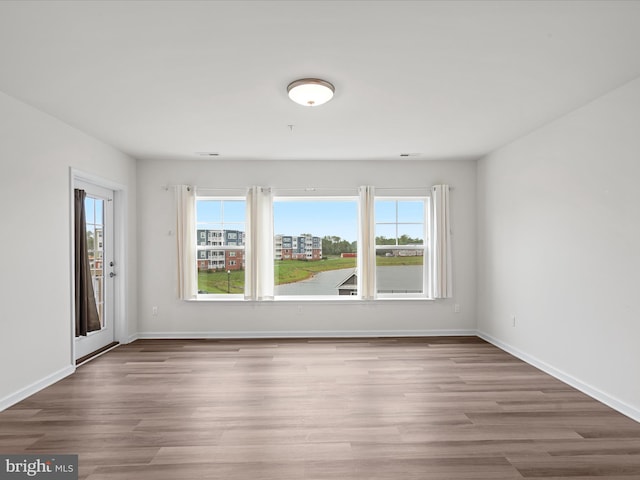 24258 Zinfandel Ln Unit R303, Lewes, DE 19958 - empty room with plenty of natural light, wood finished floors, and baseboards