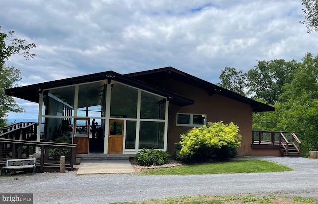 60 Woodhaven Way, Linden, VA 22642 - view of front of home with a sunroom, stucco siding, and a wooden deck