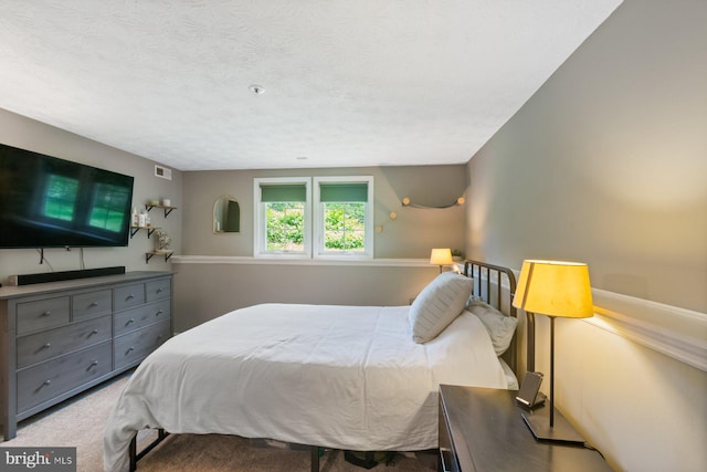 1328 Greenbriar Cir Unit 5-1328, Baltimore, MD 21208 - carpeted bedroom with a textured ceiling