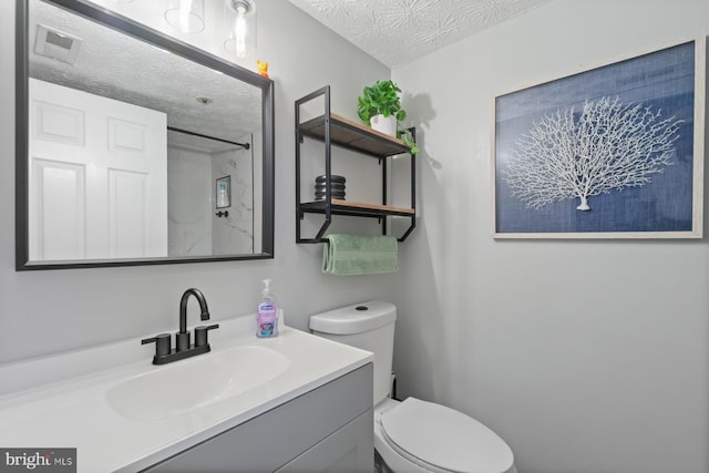1328 Greenbriar Cir Unit 5-1328, Baltimore, MD 21208 - bathroom featuring a textured ceiling, toilet, a shower, and vanity