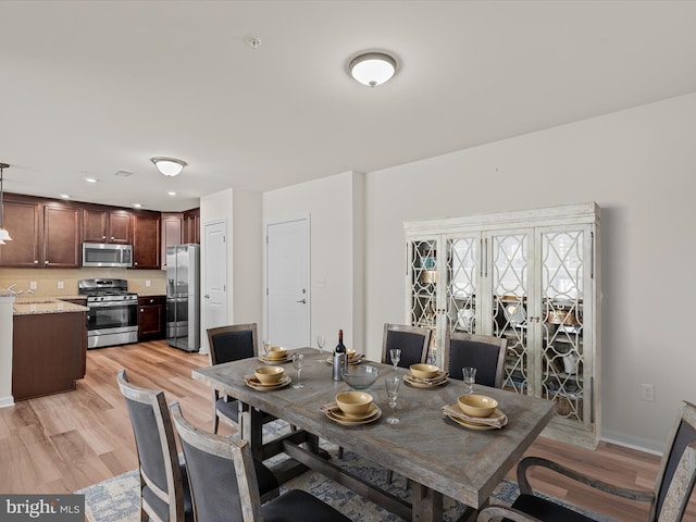 24238 Zinfandel Ln Unit R307, Lewes, DE 19958 - dining area with light wood-style flooring and baseboards