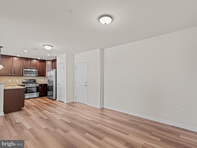 24238 Zinfandel Ln Unit R307, Lewes, DE 19958 - kitchen featuring stainless steel appliances, light wood-style flooring, a sink, dark brown cabinets, and baseboards