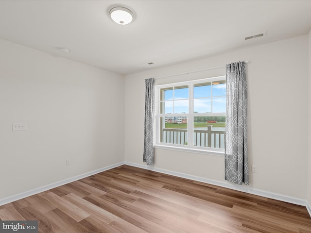24238 Zinfandel Ln Unit R307, Lewes, DE 19958 - empty room featuring wood finished floors, baseboards, a water view, and a smoke detector