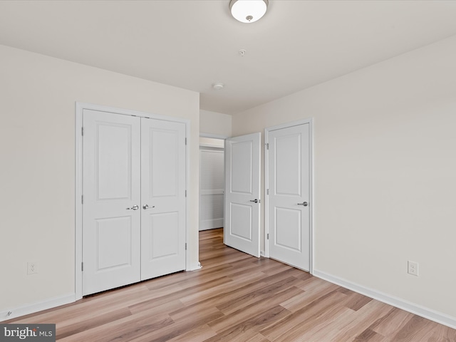 24238 Zinfandel Ln Unit R307, Lewes, DE 19958 - unfurnished bedroom with light wood-style flooring, a closet, and baseboards