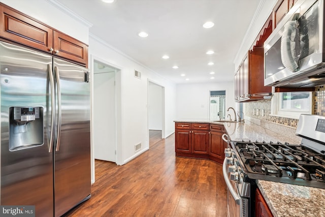 2445 Parallel Ln, Silver Spring, MD 20904 - kitchen featuring appliances with stainless steel finishes, crown molding, dark wood-style floors, a sink, and decorative backsplash