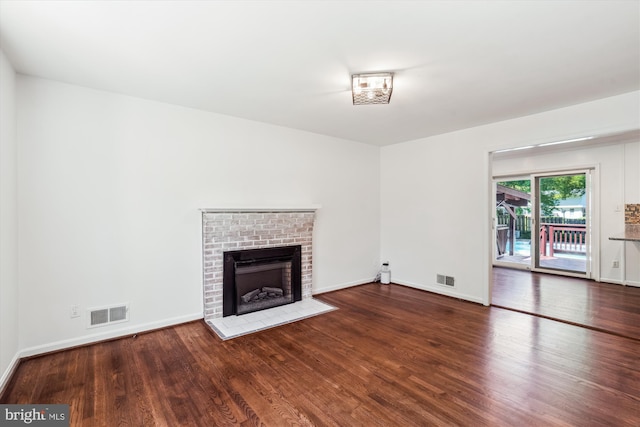 2445 Parallel Ln, Silver Spring, MD 20904 - unfurnished living room featuring wood finished floors, a brick fireplace, and baseboards