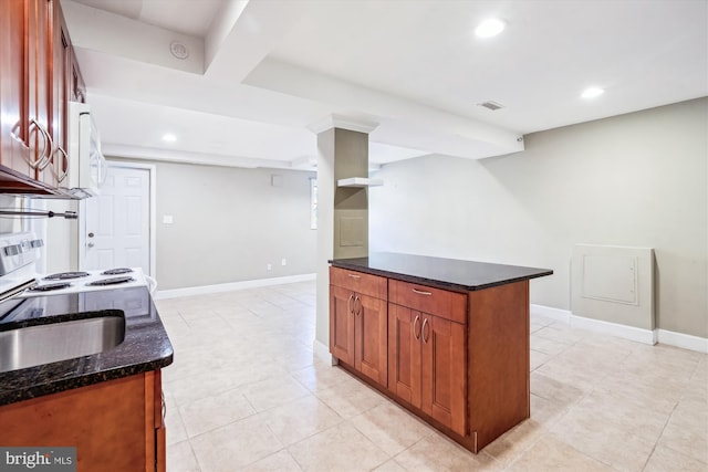 2445 Parallel Ln, Silver Spring, MD 20904 - kitchen featuring dark stone countertops, recessed lighting, baseboards, brown cabinetry, and white microwave