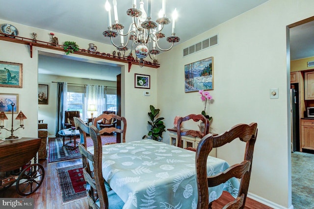 56 Zachary Dr, Chalfont, PA 18914 - dining room with wood finished floors, a chandelier, and baseboards