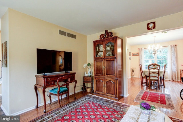 56 Zachary Dr, Chalfont, PA 18914 - living area featuring a chandelier, wood finished floors, and baseboards