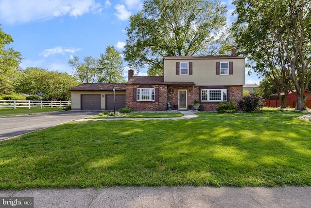 1908 Sterigere St, Eagleville, PA 19403 - view of front facade featuring a chimney, asphalt driveway, a garage, and brick siding