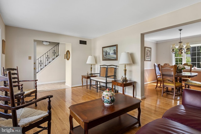 1908 Sterigere St, Eagleville, PA 19403 - living area featuring stairway, light wood-style floors, baseboards, and a chandelier