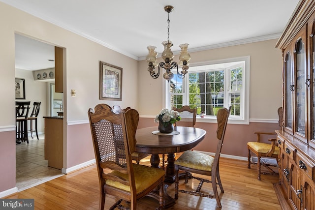 1908 Sterigere St, Eagleville, PA 19403 - dining space with light wood-type flooring, a chandelier, baseboards, and crown molding
