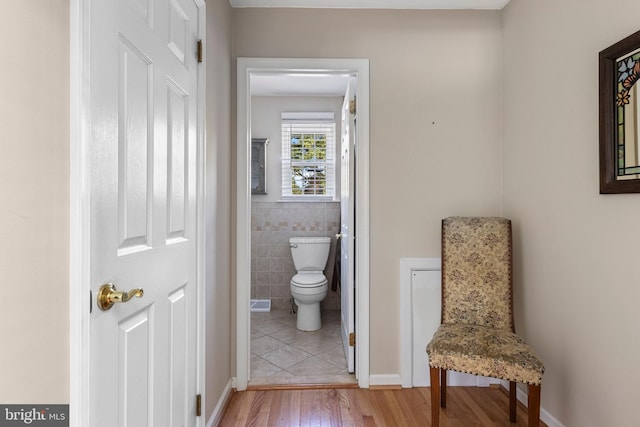 1908 Sterigere St, Eagleville, PA 19403 - bathroom featuring toilet, wood finished floors, and tile walls