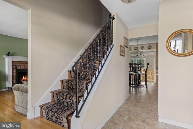 1908 Sterigere St, Eagleville, PA 19403 - stairway with a brick fireplace, a ceiling fan, and baseboards