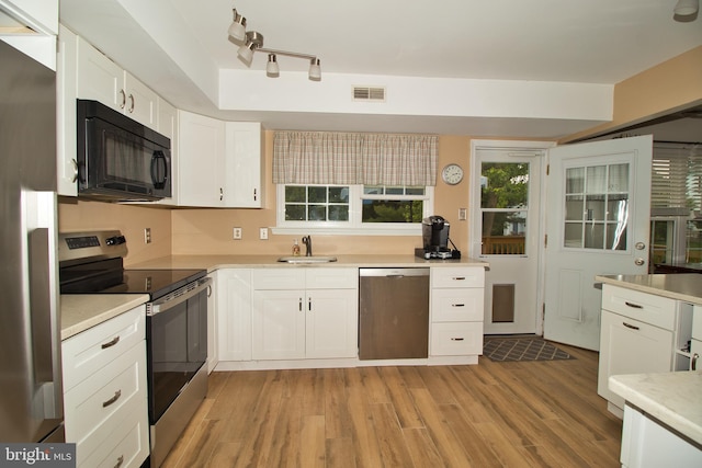 113 Megan Cir, Chalfont, PA 18914 - kitchen featuring stainless steel appliances, a sink, light wood-style floors, white cabinets, and light countertops