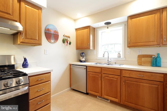 218 Independence Ave, State College, PA 16801 - kitchen with stainless steel appliances, a sink, range hood, light countertops, and brown cabinets