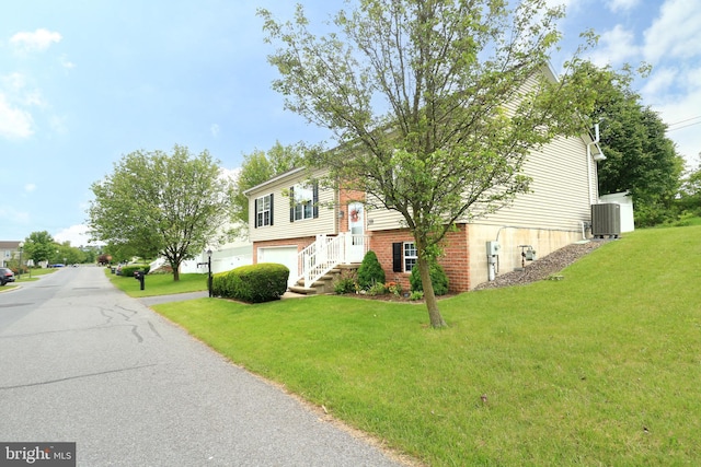 218 Independence Ave, State College, PA 16801 - raised ranch with an attached garage, a front lawn, asphalt driveway, and central AC unit