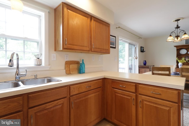 218 Independence Ave, State College, PA 16801 - kitchen featuring a sink, a peninsula, light countertops, and brown cabinetry