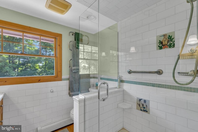 484 Rte 518, Skillman, NJ 08558 - bathroom featuring tile walls, a shower stall, a baseboard heating unit, toilet, and vanity